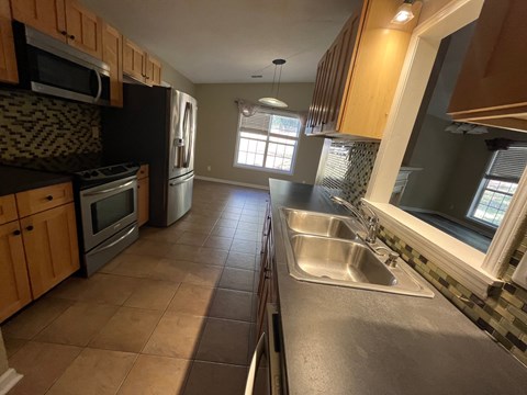 A kitchen with a sink and a window.