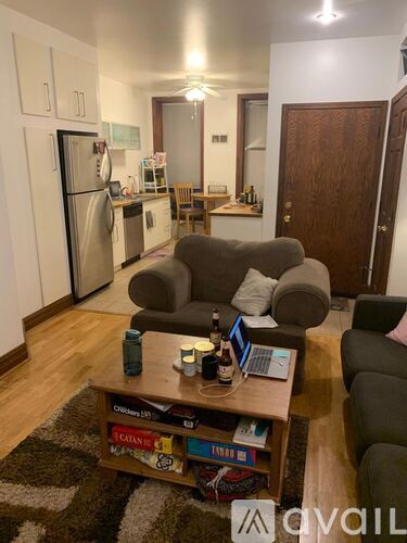 A living room with a couch, a coffee table, and a bookshelf.