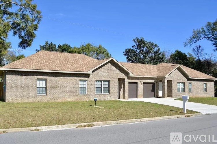A house with a brown roof and a sign that says "available" in front of it.