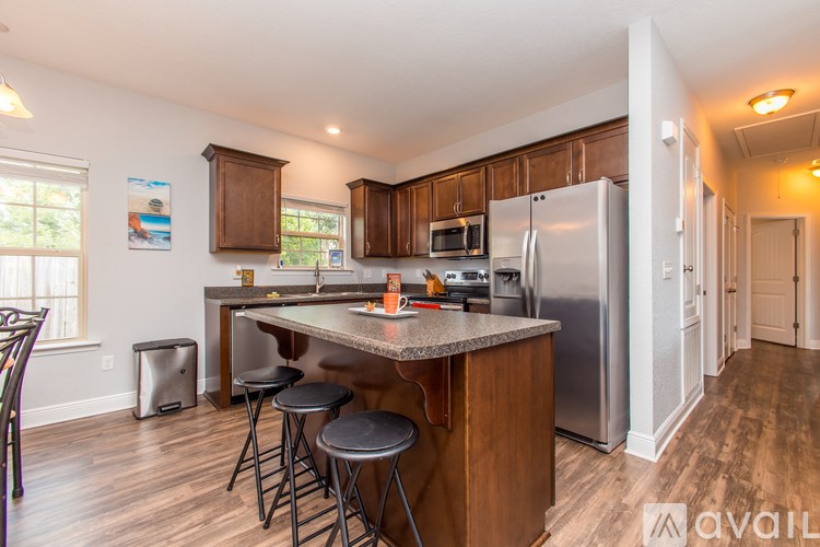 A kitchen with wooden cabinets and a granite countertop.