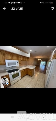 A kitchen with wooden cabinets and a white oven.