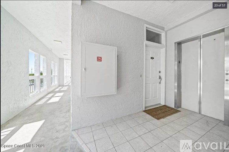 A white room with a door and a window.