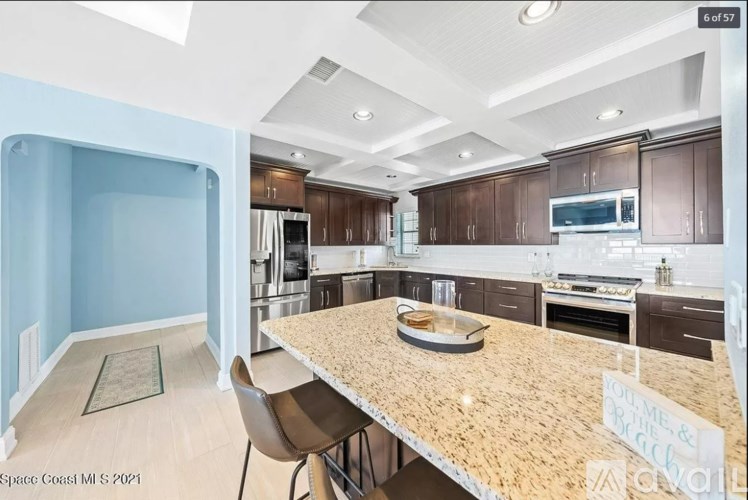A kitchen with a table and chairs in the middle of it.