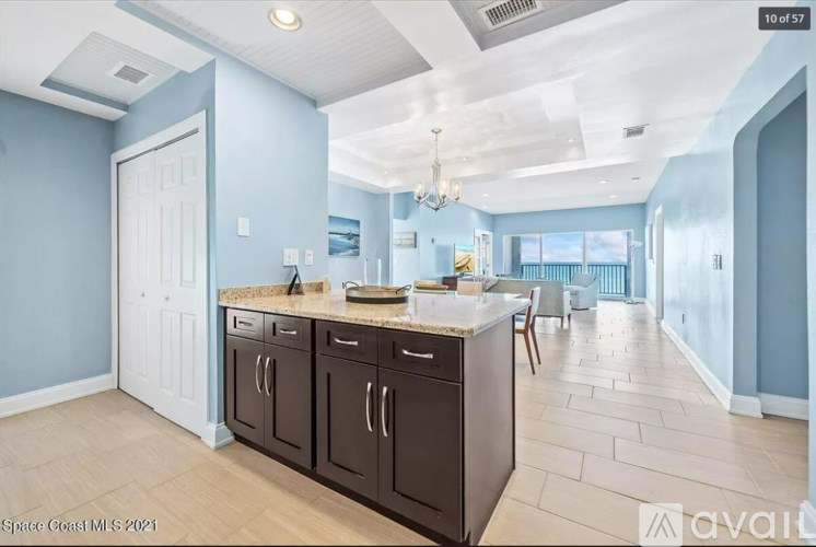 A kitchen with a sink, cabinets, and a countertop.
