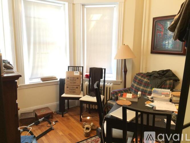 A room with a chair, a table, and a sign on the floor.