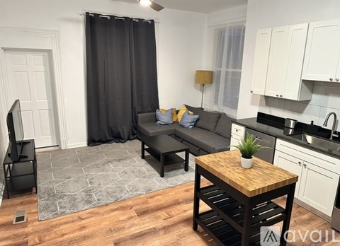 A modern living room with a grey sofa and a wooden coffee table.