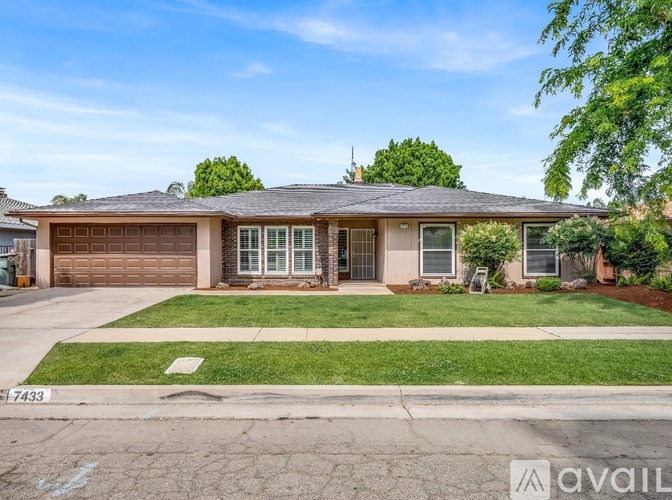 A house with a brown garage door is for sale.