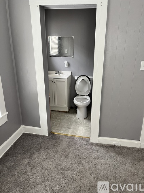 A bathroom with a toilet and sink in a small space.