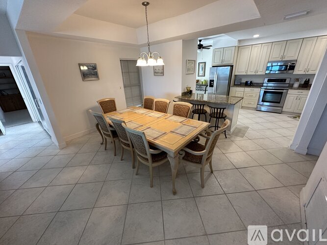 A dining room with a table set for six.