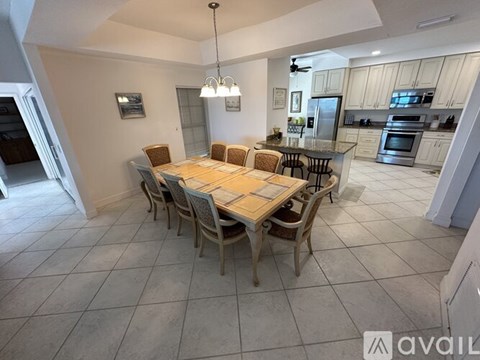 A dining room with a table set for six.