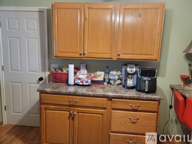 A kitchen with wooden cabinets and a granite countertop.