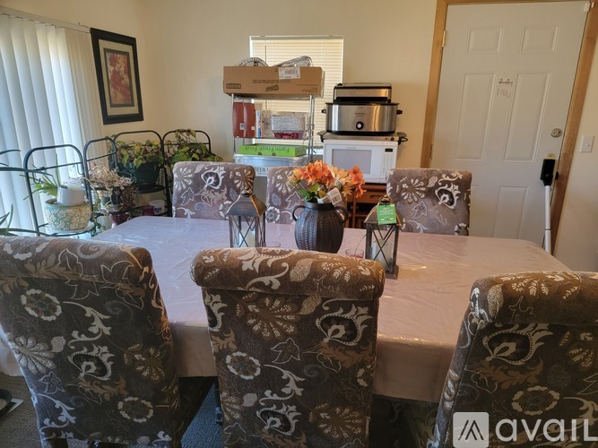 A dining room with a table set for a meal.