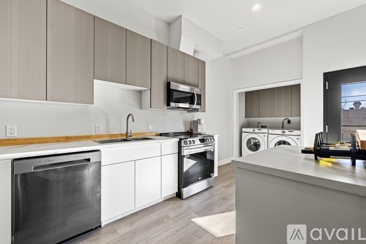 A modern kitchen with a stainless steel dishwasher and oven.