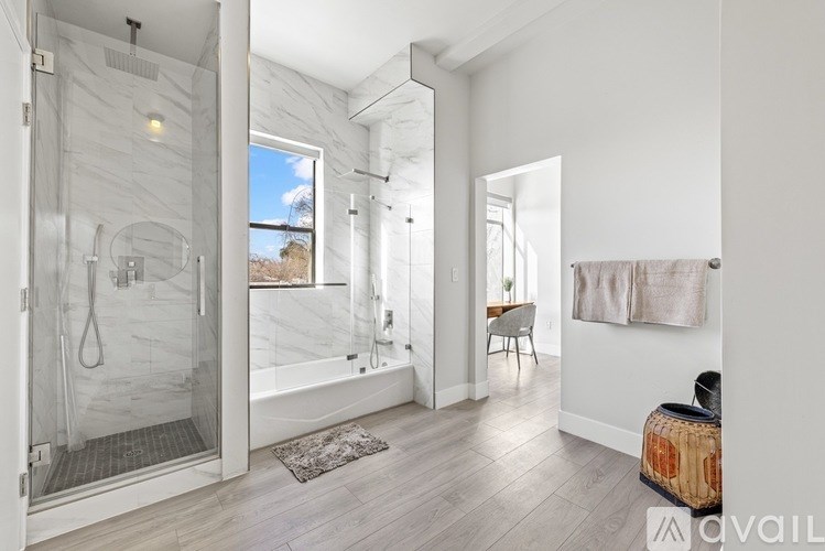 A bathroom with a walk-in shower and a window.