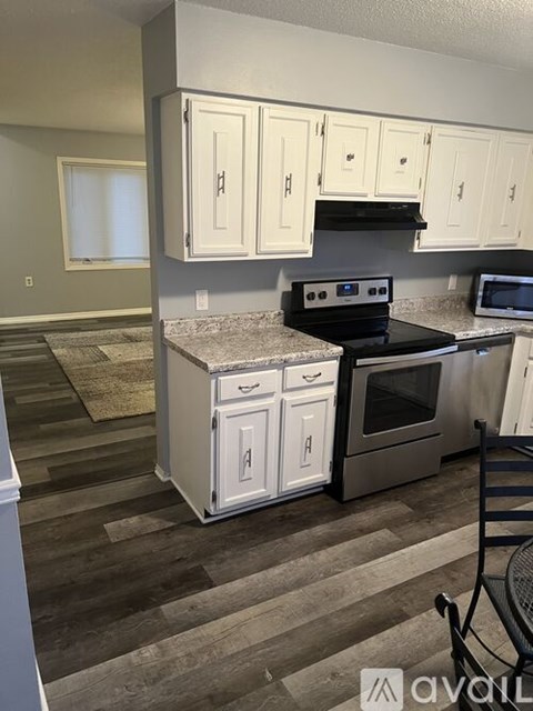 A kitchen with a stove top oven and a microwave.