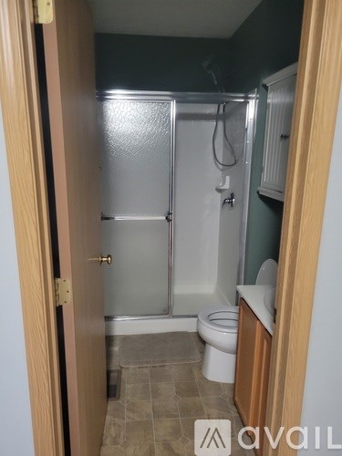A bathroom with a toilet, sink, and shower.