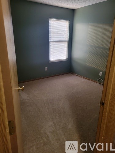 A room with a window and a door.