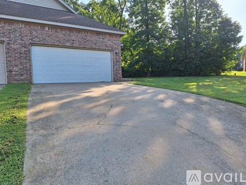A driveway leads to a garage with a white door.