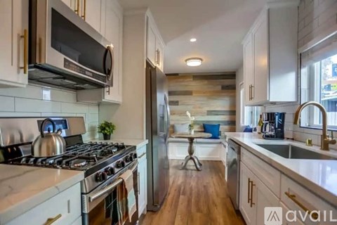 A modern kitchen with a stove top oven and a refrigerator.