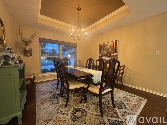 A dining room with a table set for four.