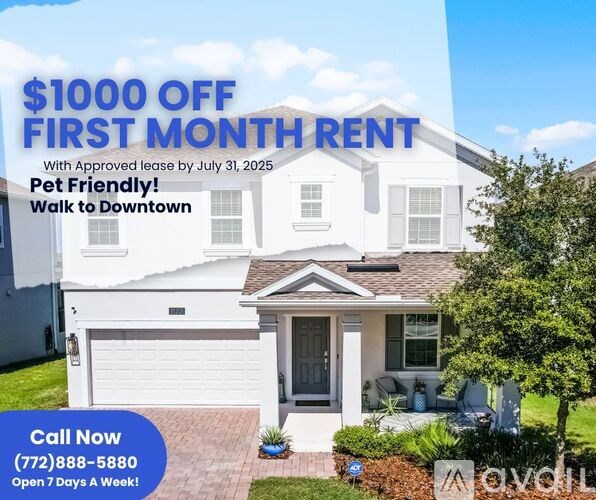 A white house with a sign offering $1000 off the first month's rent.