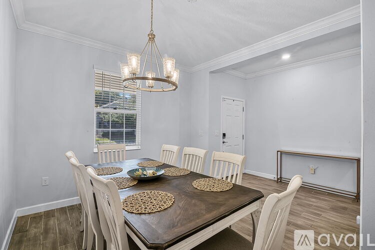 A dining room with a wooden table and chairs.
