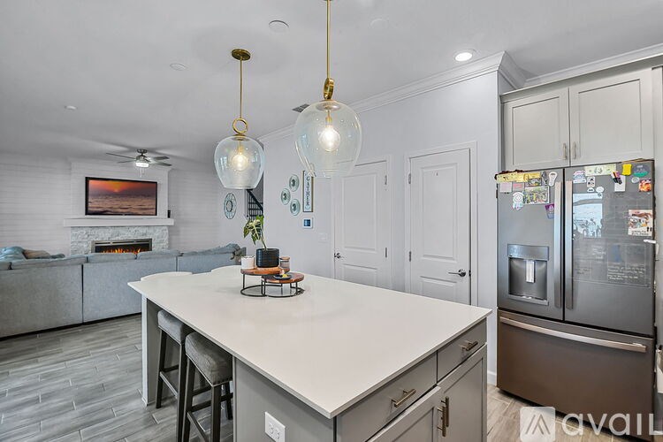 A kitchen with a white countertop and a refrigerator with many magnets on it.