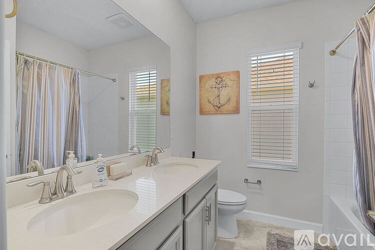 A bathroom with a white sink and a toilet.