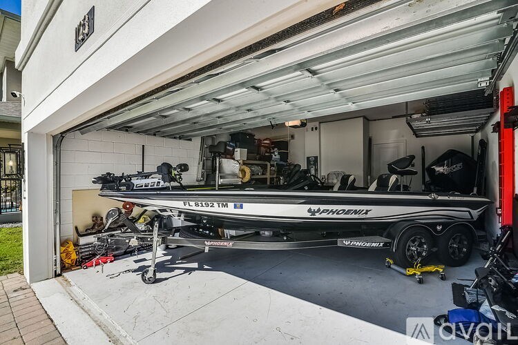 A boat is parked in a garage with the name PHOENIX on it.