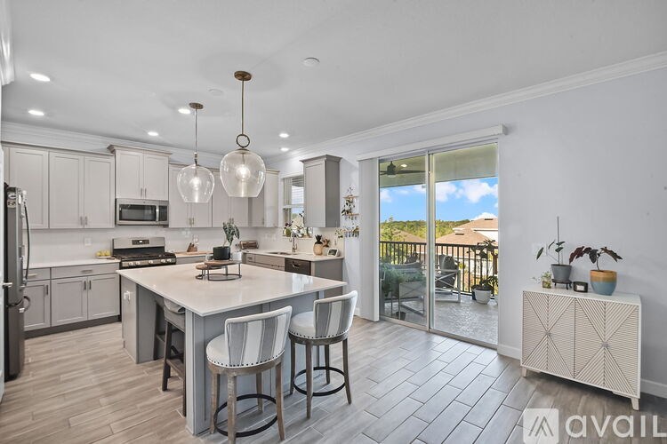 A kitchen with a bar stool and a table with chairs.