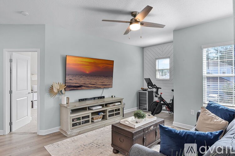 A living room with a television, a couch, and a coffee table.
