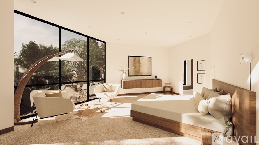 A modern bedroom with a large bed and a chair by the window.