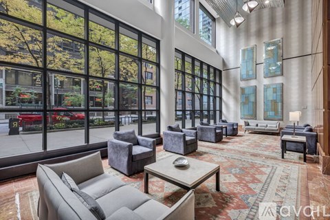 A living room with a large window overlooking a street.
