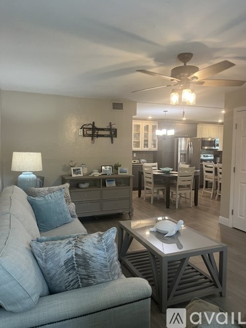 A living room with a grey couch and a coffee table.