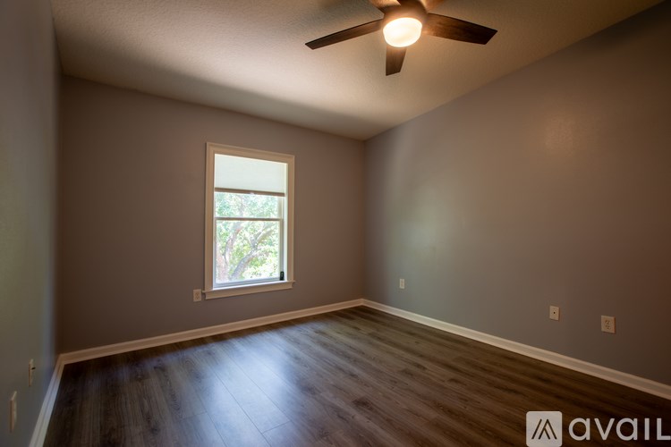 A room with a ceiling fan and a window.