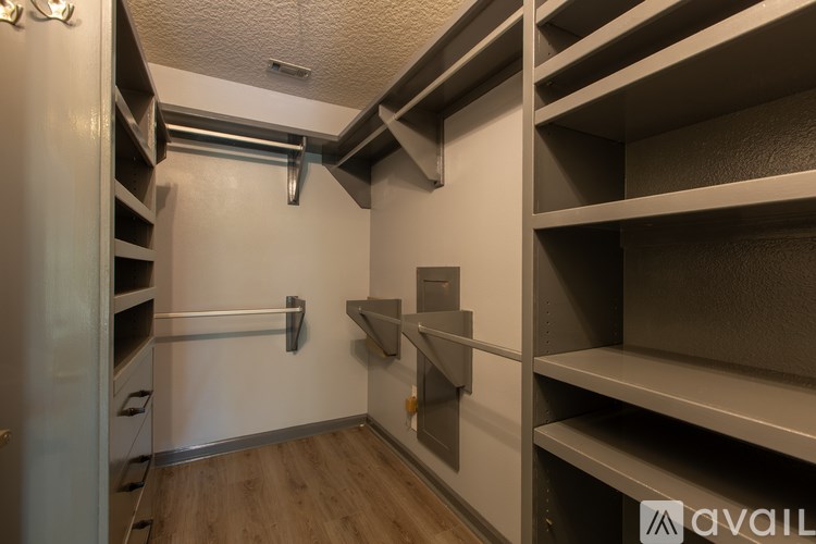 A storage room with shelves and a door.