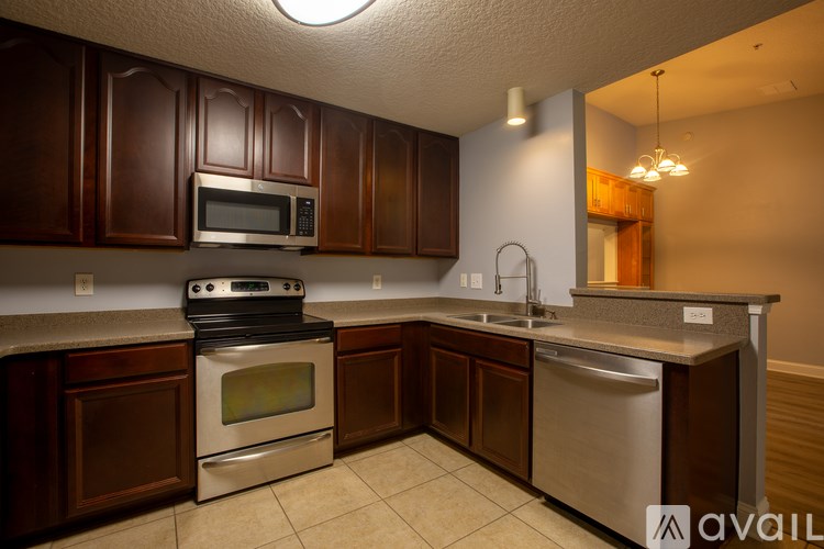 A kitchen with brown cabinets and stainless steel appliances.