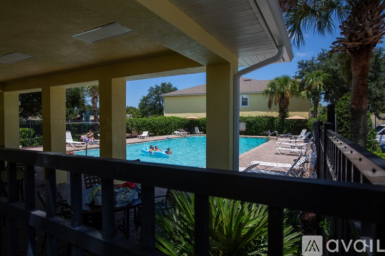 A pool with people in it is seen from a balcony.