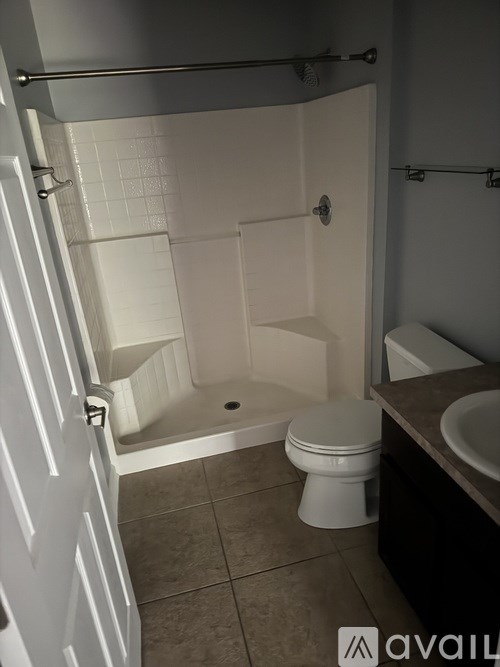 A bathroom with a toilet, sink, and bathtub.