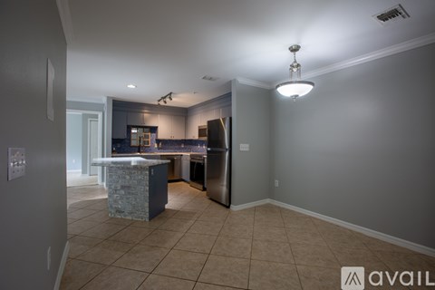 A bathroom with a walk-in shower and tiled floor.