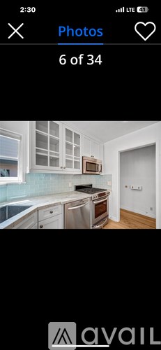 A kitchen with white cabinets and a stainless steel dishwasher.