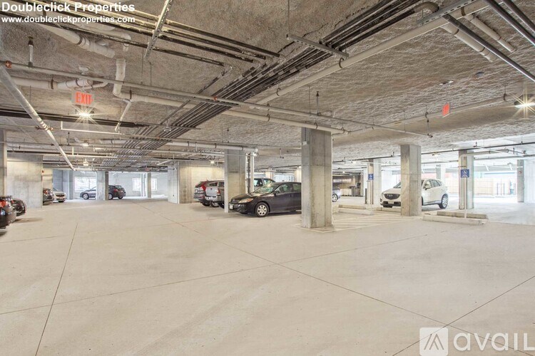 A parking garage with several cars and a sign that says "available".