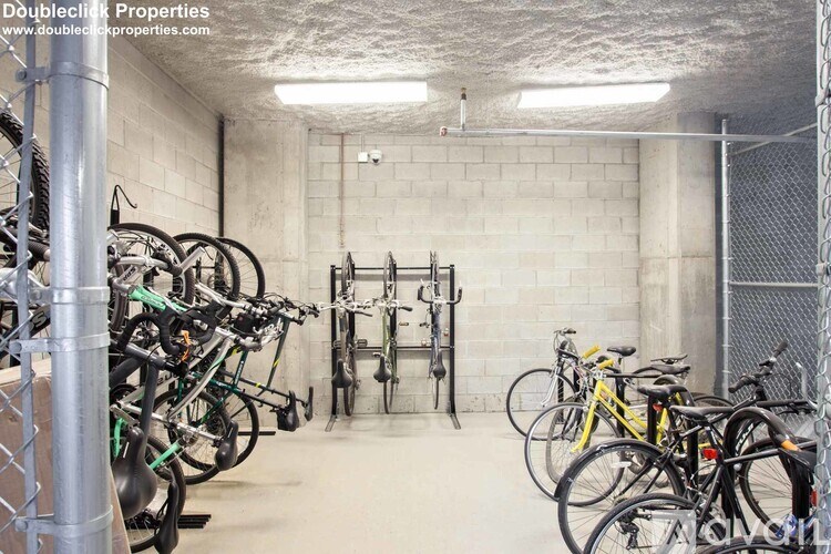 A bike parking area with bikes of various colors.