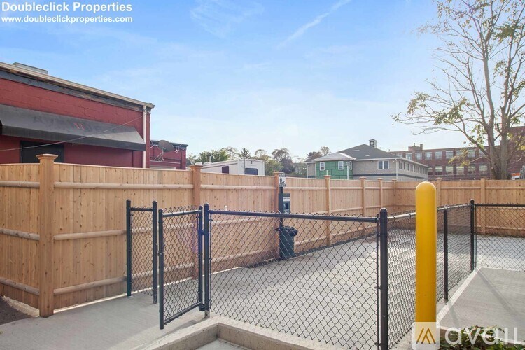 A fenced area with a yellow post in the foreground.