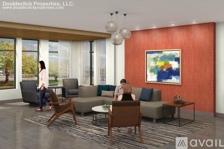 A modern living room with a woman standing and two women sitting on a couch.