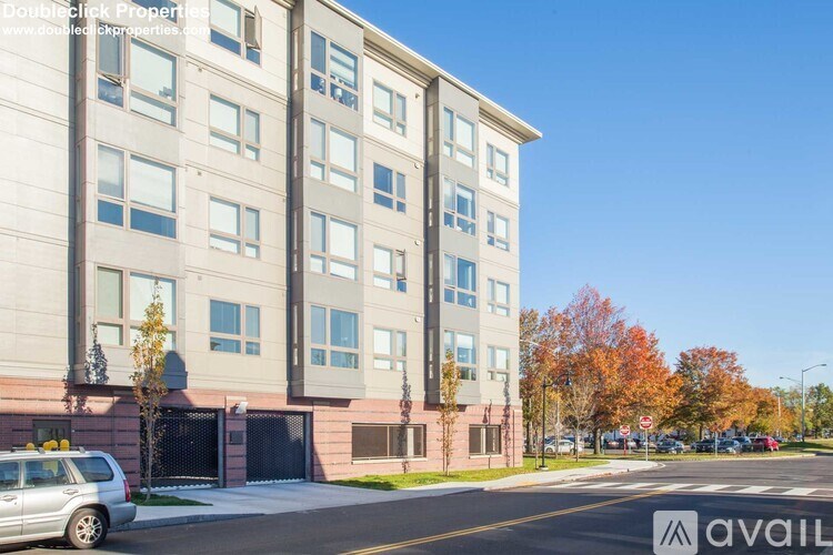 A modern apartment building with a clear blue sky above.