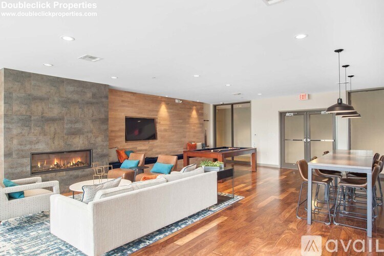 A modern living room with a fireplace and a white sofa.