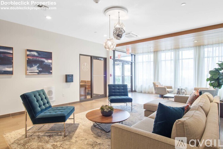 A living room with a blue chair and a couch.