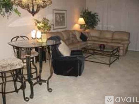 A living room with a couch, chair, and table.