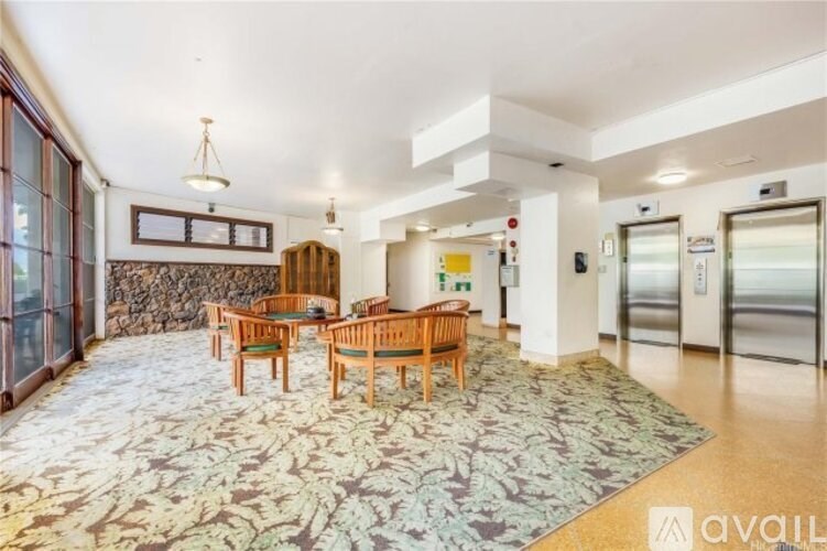 A kitchen with a stainless steel refrigerator and a microwave on the counter.